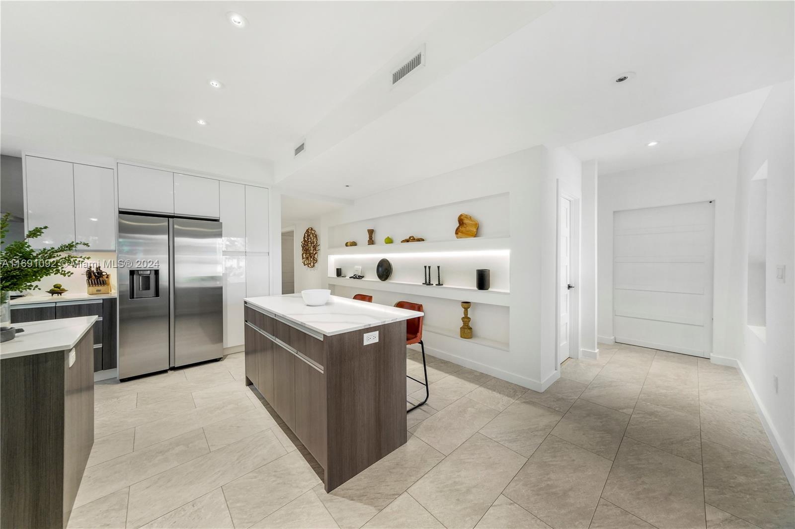 2429 Southwest 25th Terrace Miami, FL 33133 - Photo 14 of 35 a kitchen with stainless steel appliances granite countertop a stove and a refrigerator