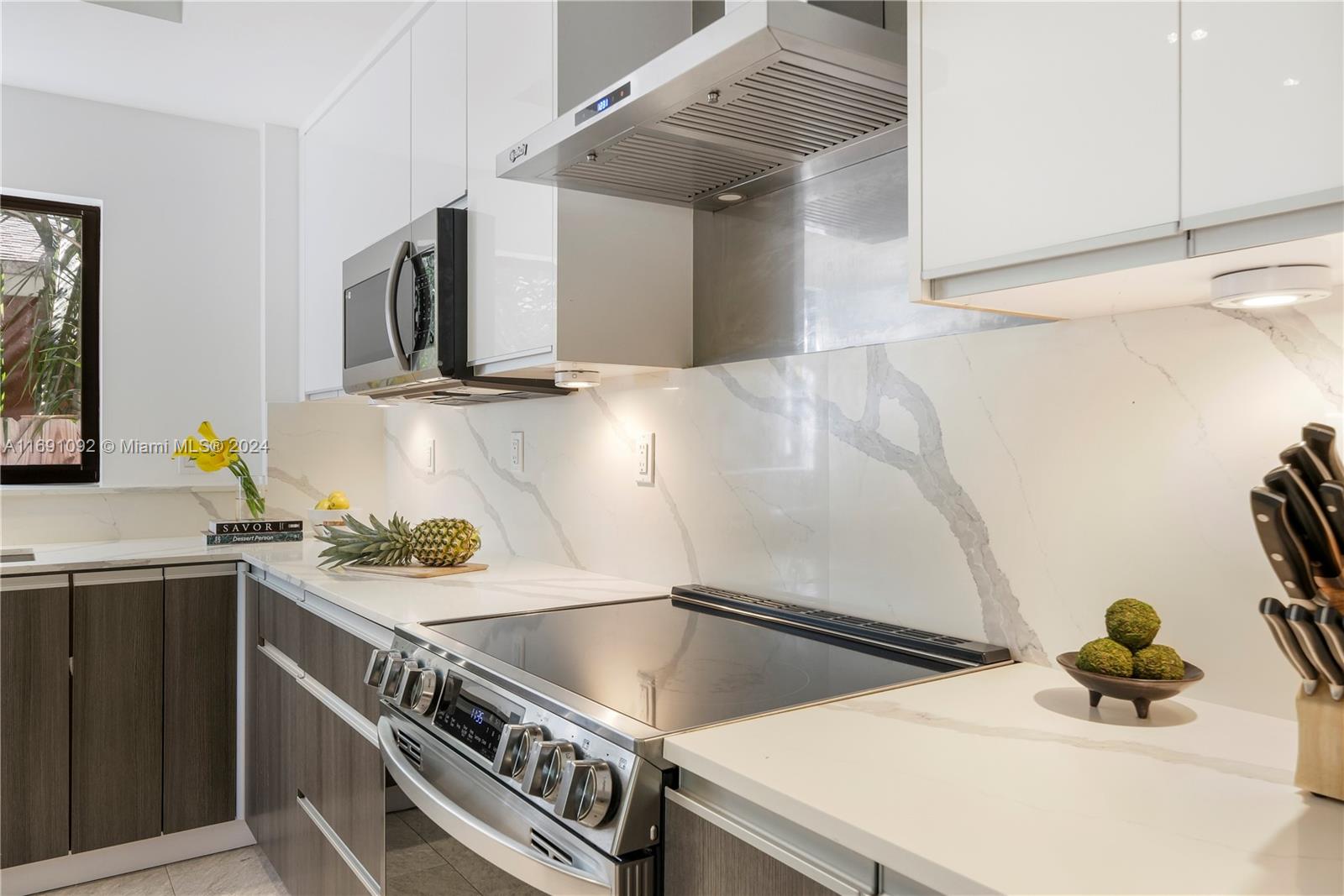 2429 Southwest 25th Terrace Miami, FL 33133 - Photo 20 of 35 a kitchen with a sink and a stove top oven