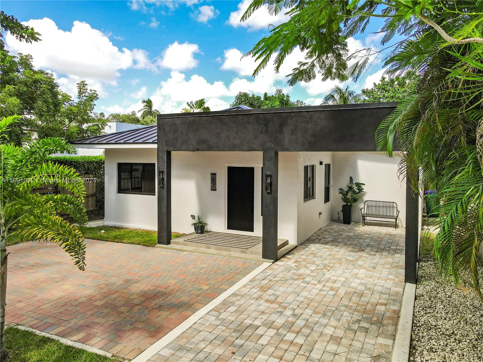 2429 Southwest 25th Terrace Miami, FL 33133 - Photo 2 of 35 a front view of a house with a garden