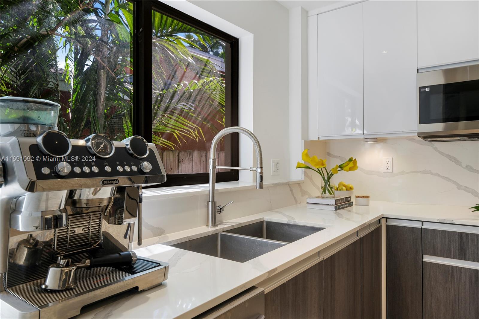 2429 Southwest 25th Terrace Miami, FL 33133 - Photo 21 of 35 a kitchen with a sink a counter and a stove