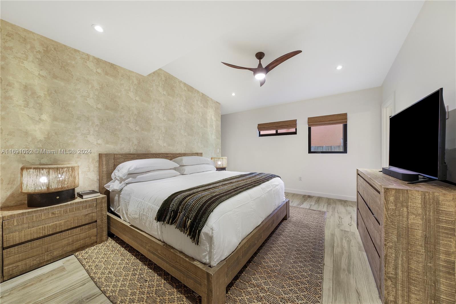 2429 Southwest 25th Terrace Miami, FL 33133 - Photo 22 of 35 a bedroom with a bed and a flat screen tv