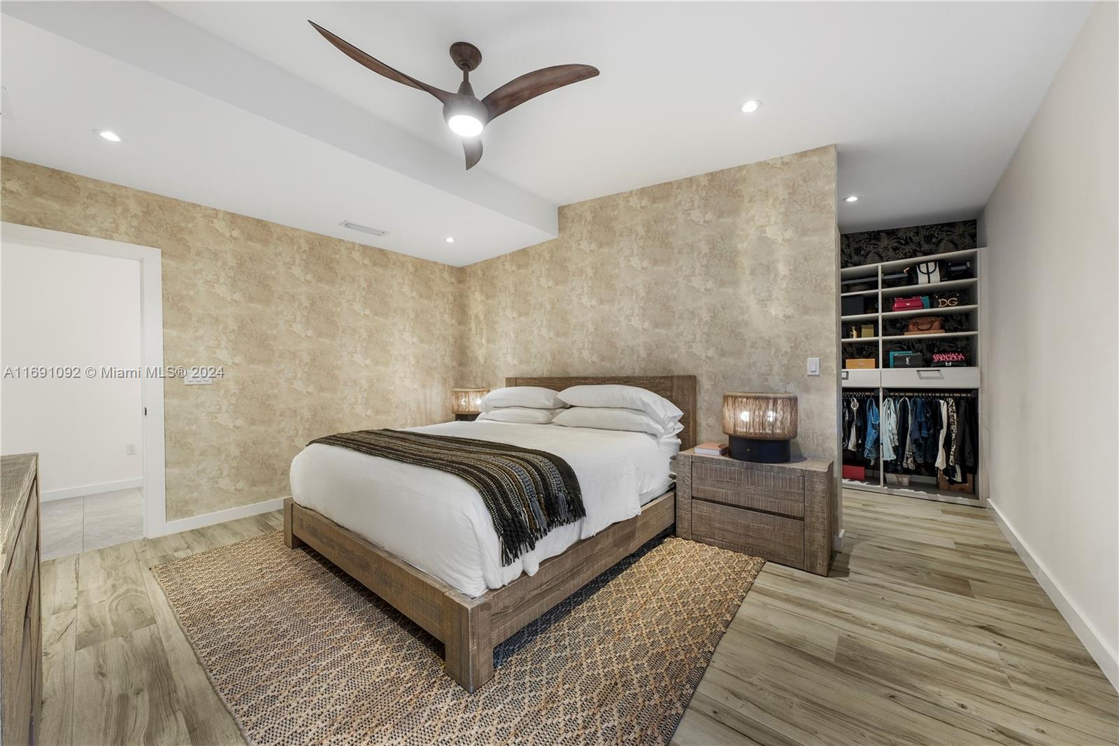 2429 Southwest 25th Terrace Miami, FL 33133 - Photo 24 of 35 a bedroom with a bed and closet with wooden floor