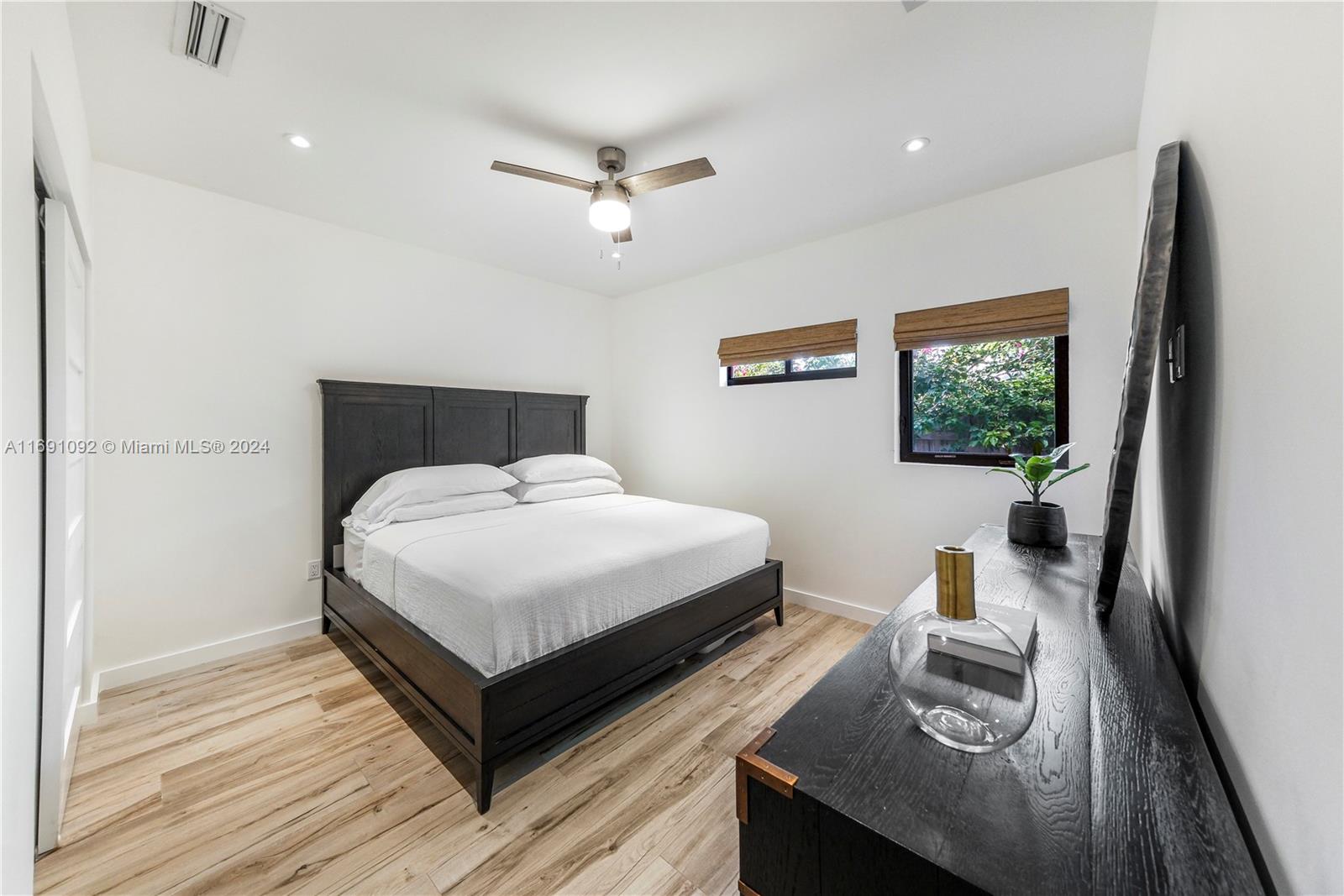 2429 Southwest 25th Terrace Miami, FL 33133 - Photo 26 of 35 a bedroom with a bed and wooden floor