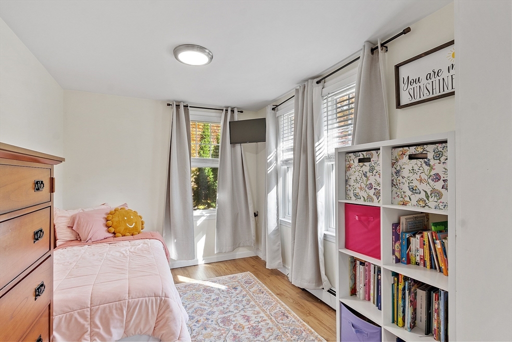 66 Dawson Road Worcester, MA 01602 - Photo 21 of 40 a bedroom with a bed and a book shelf