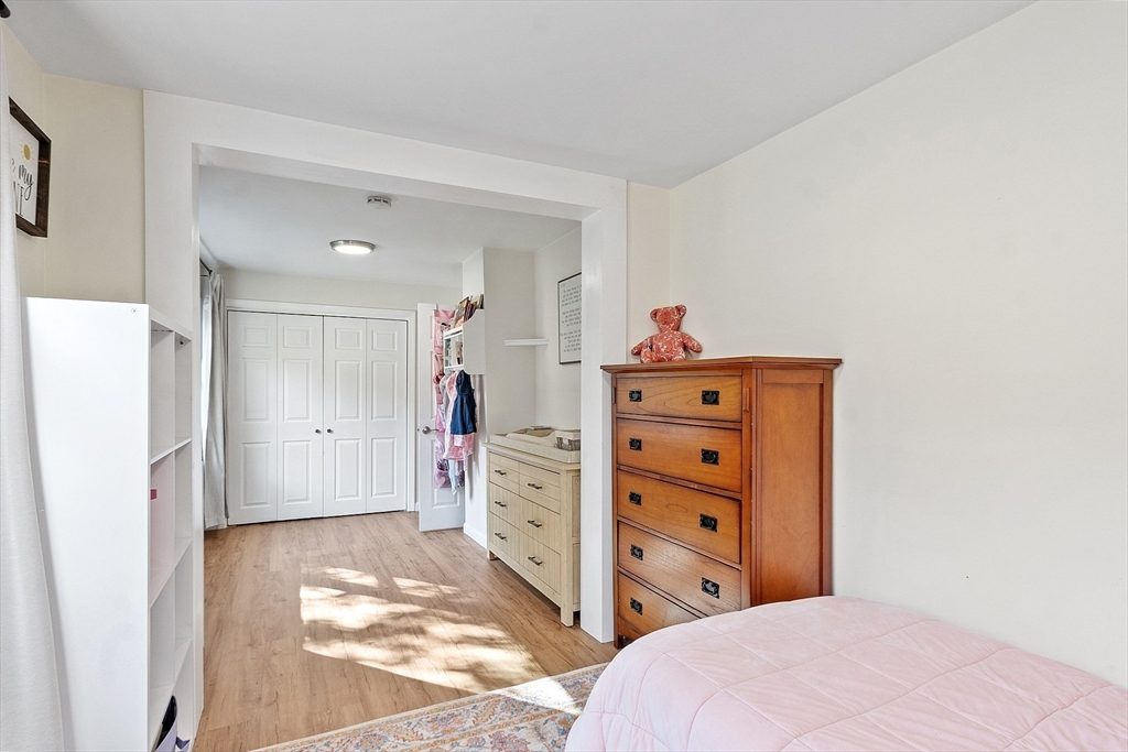 66 Dawson Road Worcester, MA 01602 - Photo 23 of 40 a bedroom with a dresser and a chandelier