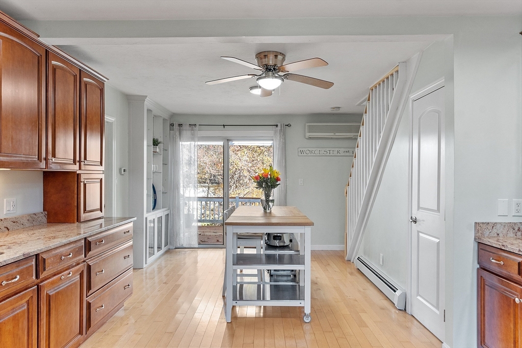 66 Dawson Road Worcester, MA 01602 - Photo 4 of 40 a dining room with wooden floor a chandelier a wooden table and chairs