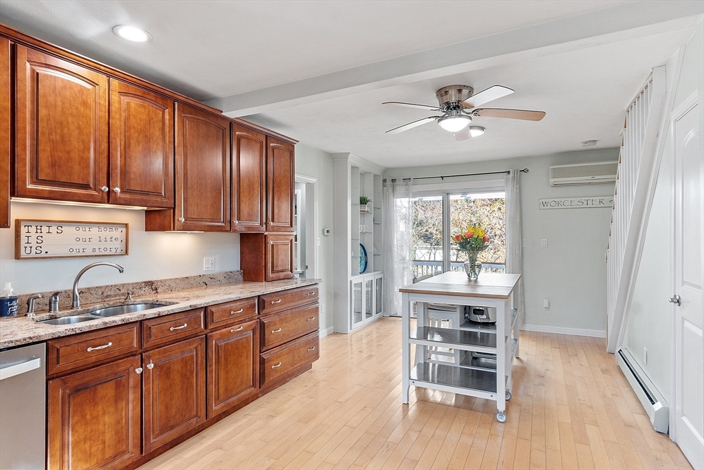 66 Dawson Road Worcester, MA 01602 - Photo 5 of 40 a kitchen with kitchen island granite countertop wooden cabinets a refrigerator a sink and dishwasher
