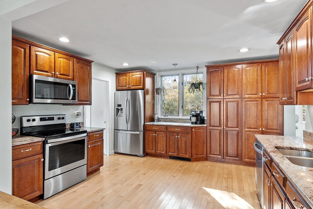 66 Dawson Road Worcester, MA 01602 - Photo 7 of 40 a kitchen with stainless steel appliances granite countertop a stove top oven a sink and a refrigerator