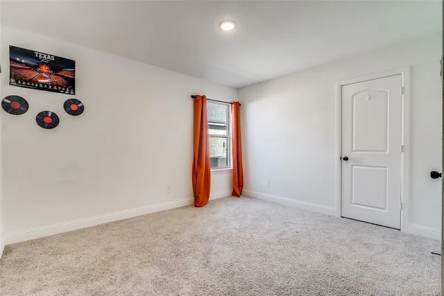 an empty room with window and closet