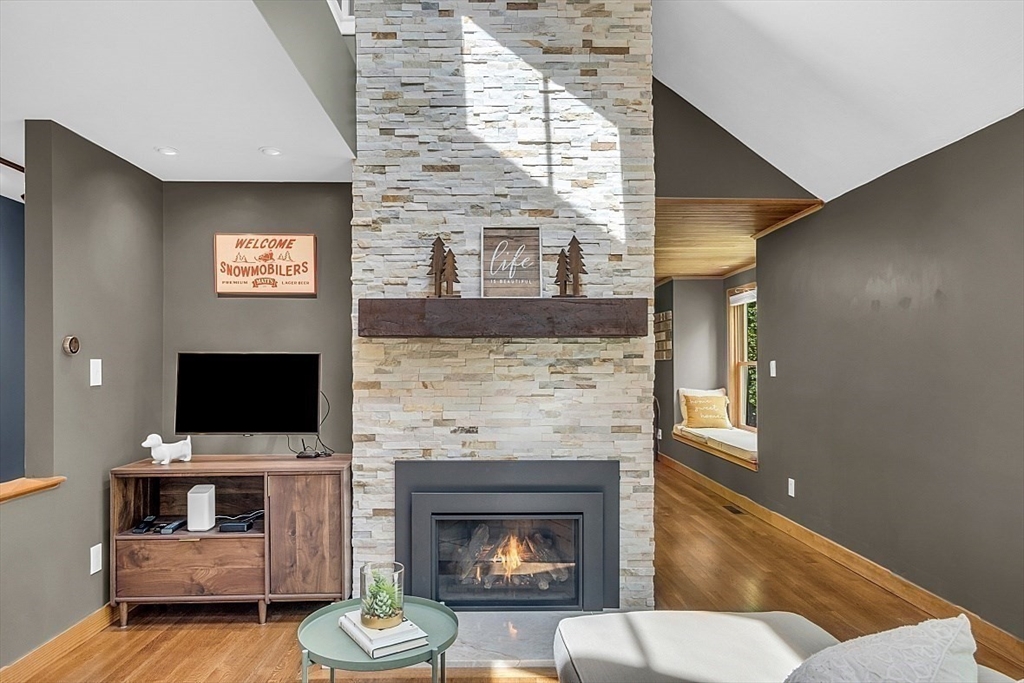 3 Valley Road North Reading, MA 01864 - Photo 11 of 42 a living room with fireplace furniture and a flat screen tv
