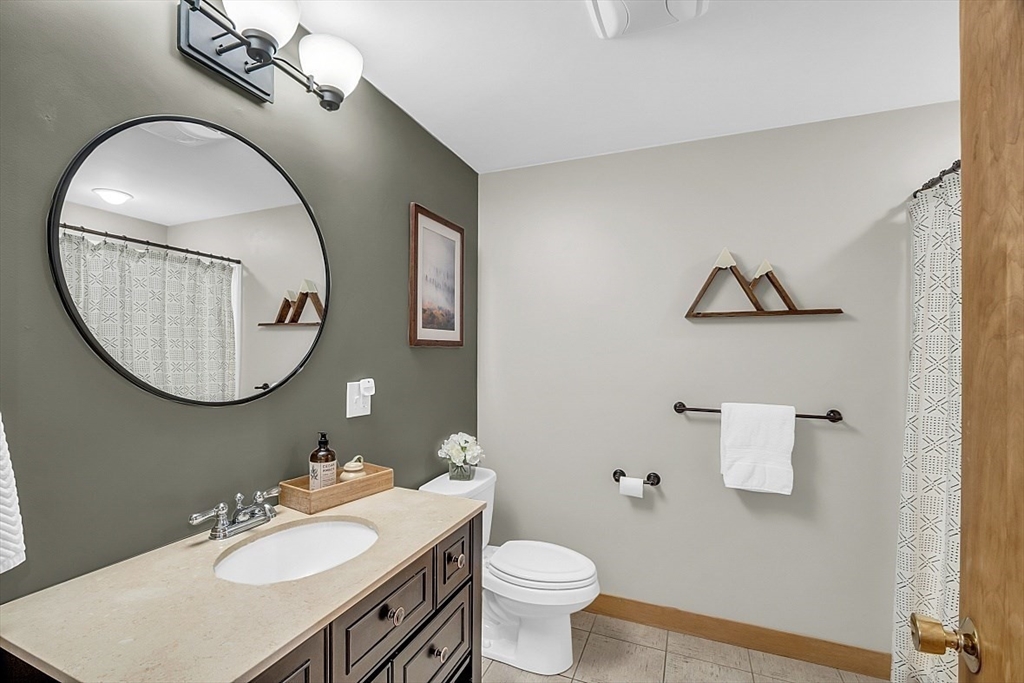 3 Valley Road North Reading, MA 01864 - Photo 16 of 42 a bathroom with a toilet a sink and mirror