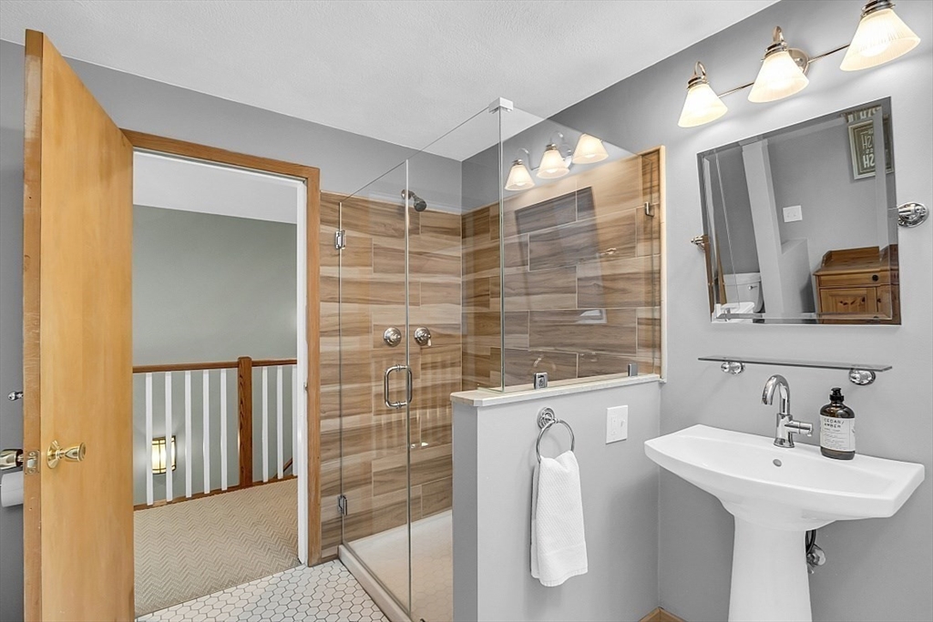 3 Valley Road North Reading, MA 01864 - Photo 18 of 42 a bathroom with a sink a mirror and a shower