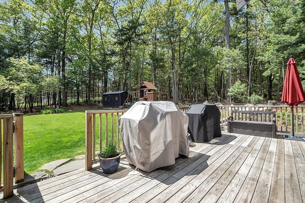 3 Valley Road North Reading, MA 01864 - Photo 33 of 42 a view of a deck with a table and chairs next to a yard