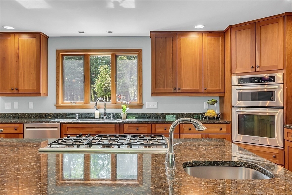 3 Valley Road North Reading, MA 01864 - Photo 5 of 42 a kitchen with granite countertop a stove a sink and a microwave