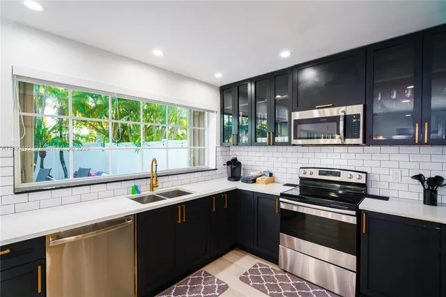a kitchen with a sink stove top oven and cabinets