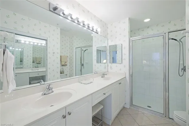 a bathroom with a sink double vanity and a mirror