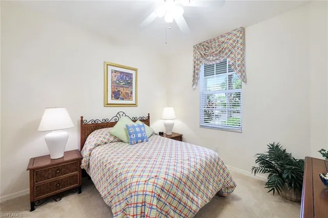 a bedroom with bed and a potted plant