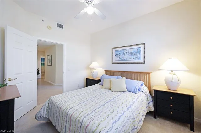 a bedroom with a bed and a lamp