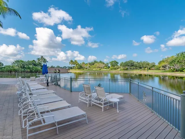 a view of a lake with couches and city view