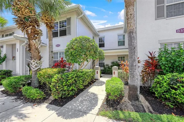 a view of a house with a yard and garden