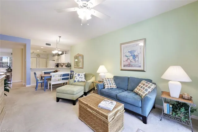 a living room with furniture and a lamp