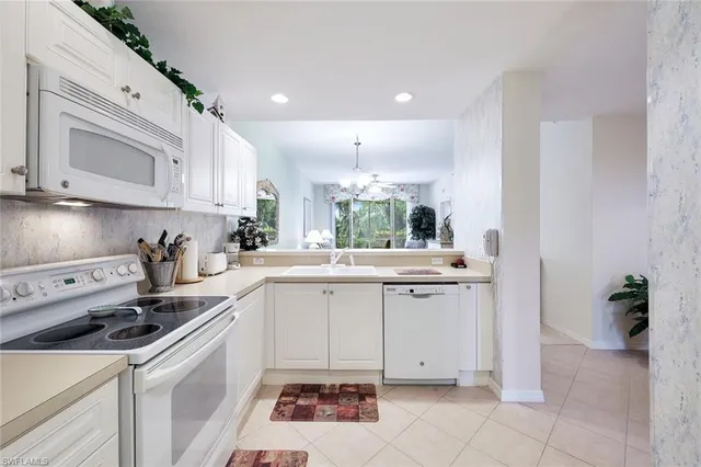 a kitchen with a sink cabinets and appliances