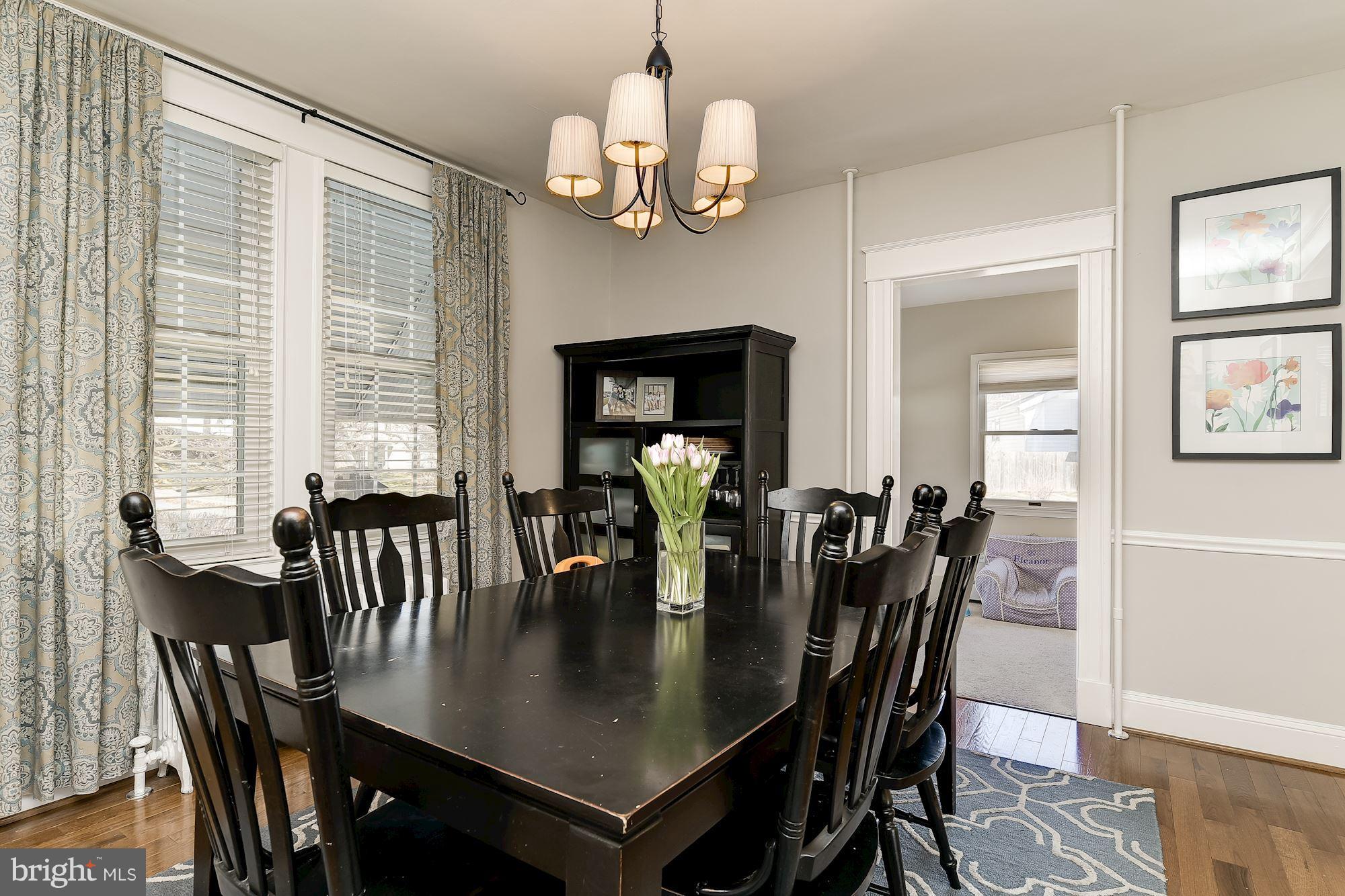 6318 Banbury Road Baltimore, MD 21212 - Photo 11 of 30 a view of a dining room with furniture a chandelier and wooden floor