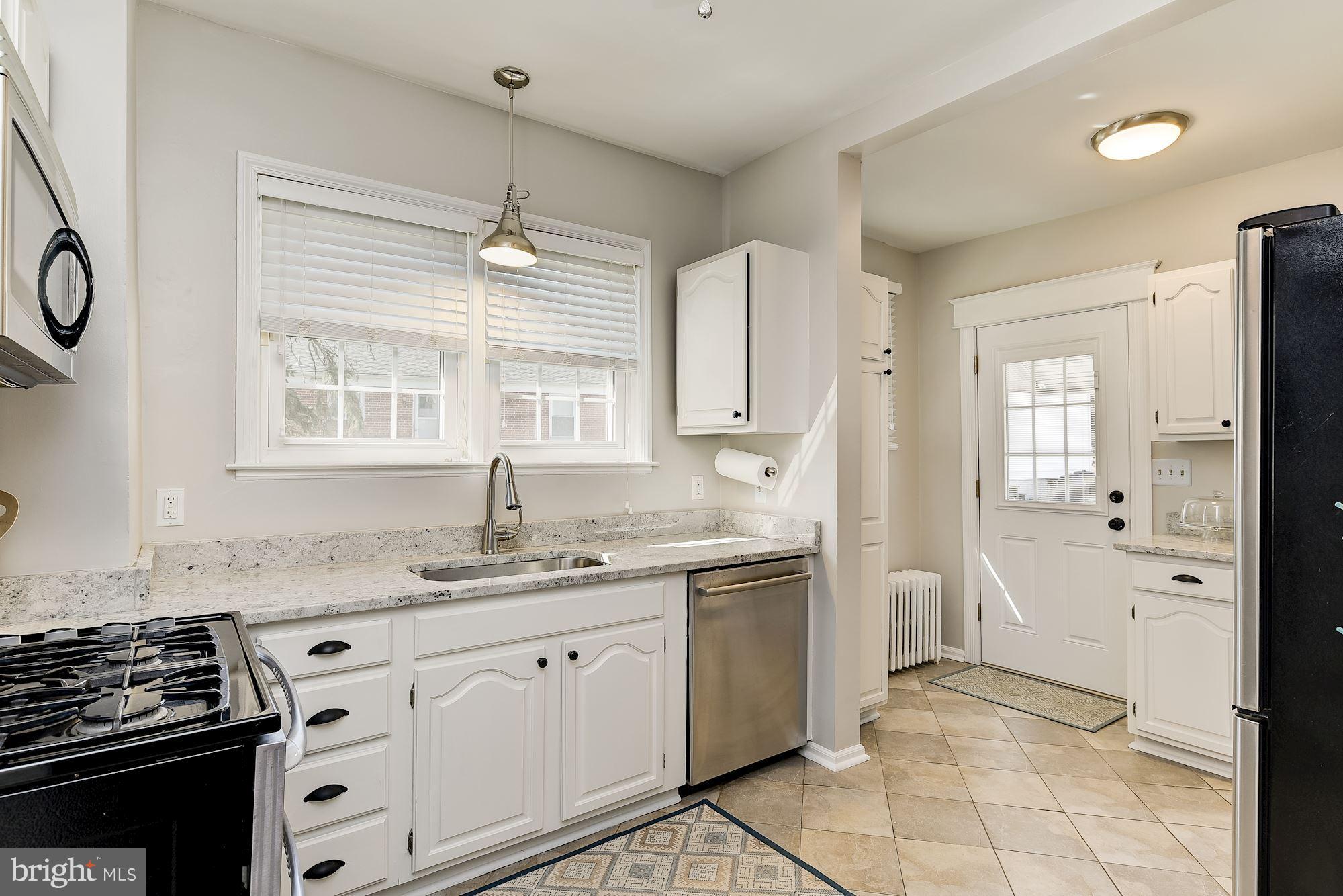 6318 Banbury Road Baltimore, MD 21212 - Photo 14 of 30 a kitchen with a sink stove and refrigerator