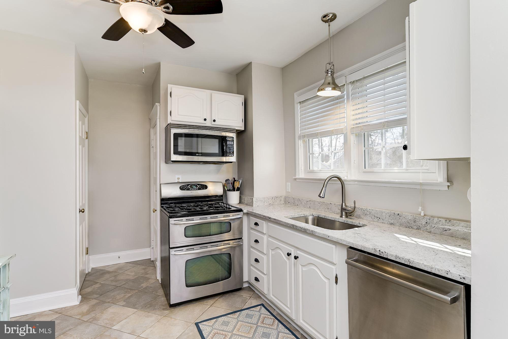 6318 Banbury Road Baltimore, MD 21212 - Photo 16 of 30 a kitchen with stainless steel appliances granite countertop a sink and cabinets