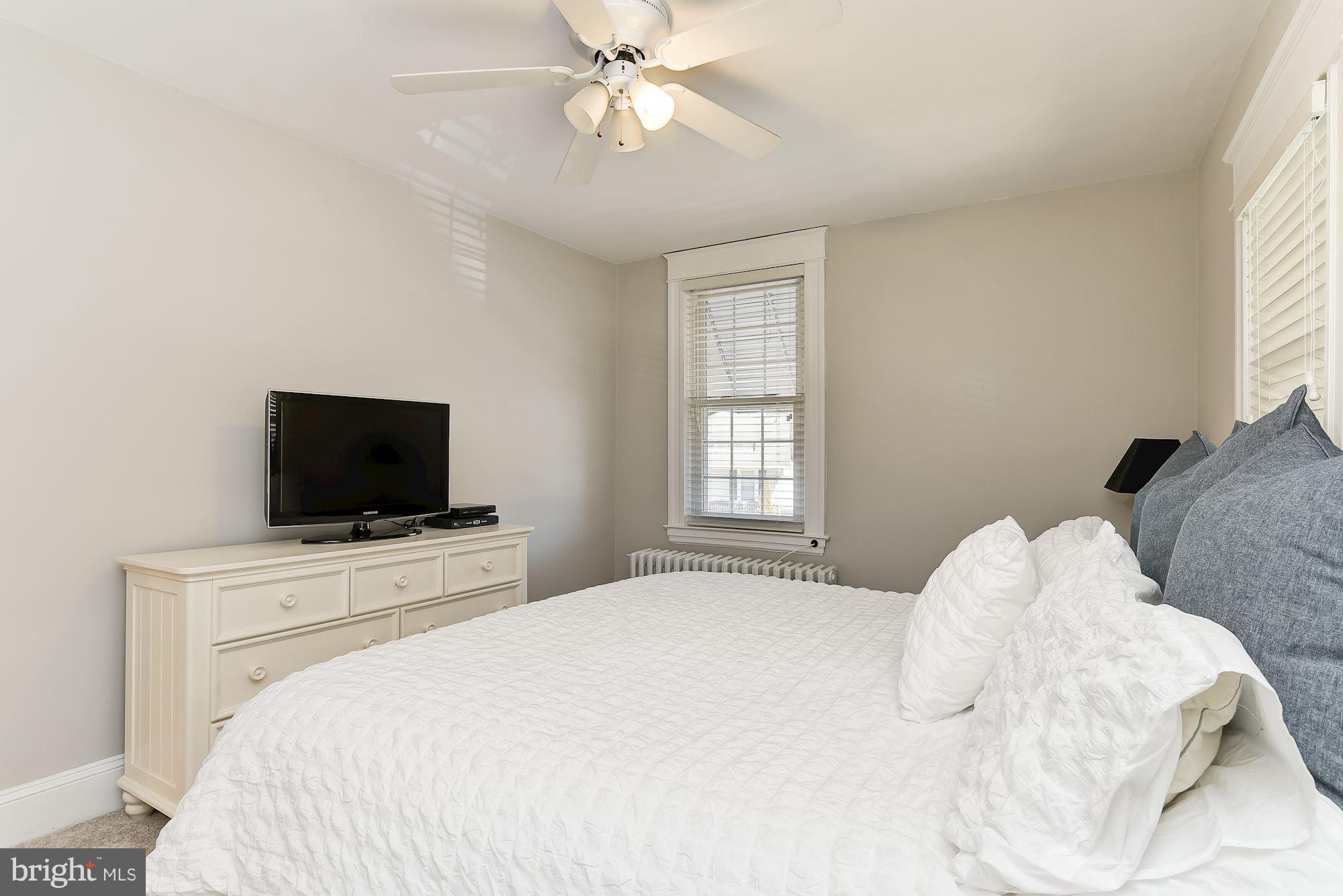 6318 Banbury Road Baltimore, MD 21212 - Photo 18 of 30 a bedroom with a bed and a flat screen tv
