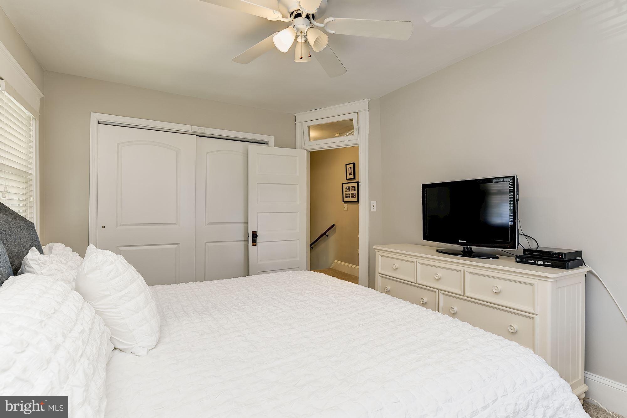 6318 Banbury Road Baltimore, MD 21212 - Photo 19 of 30 a bedroom with a bed and a flat screen tv