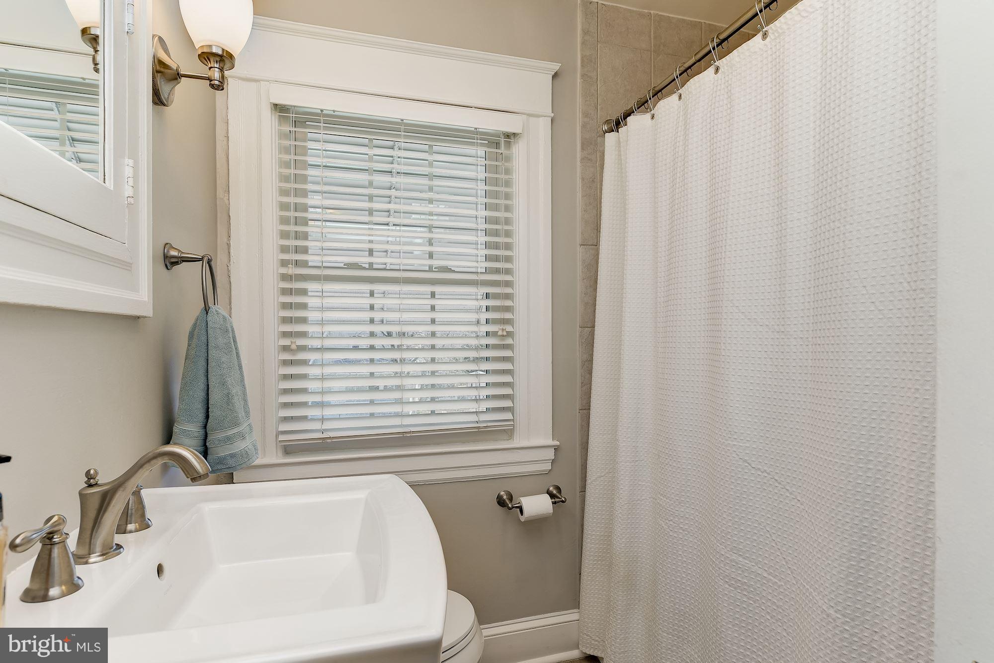 6318 Banbury Road Baltimore, MD 21212 - Photo 24 of 30 a bathroom with a sink a toilet and shower