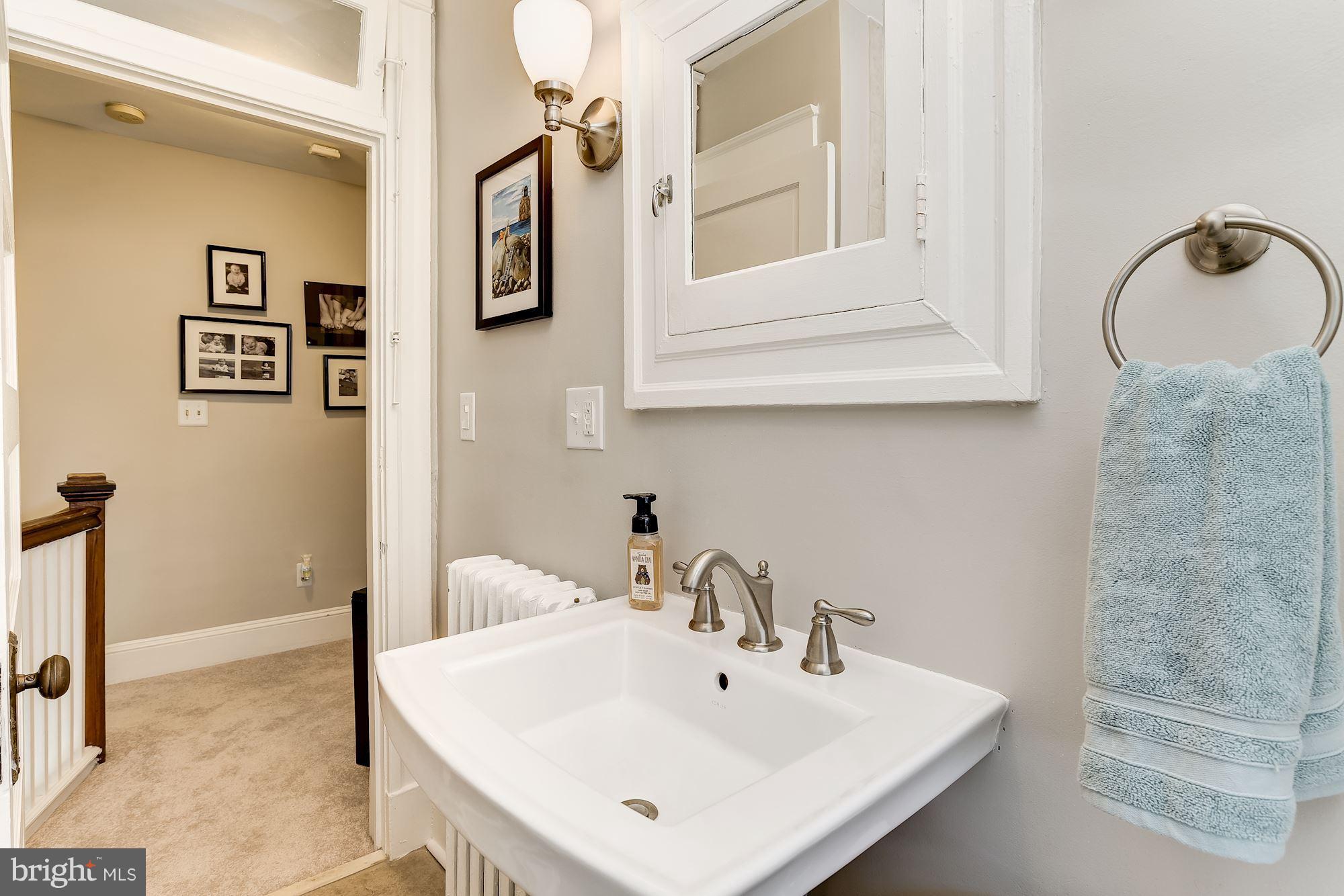 6318 Banbury Road Baltimore, MD 21212 - Photo 25 of 30 a bathroom with a sink and a mirror