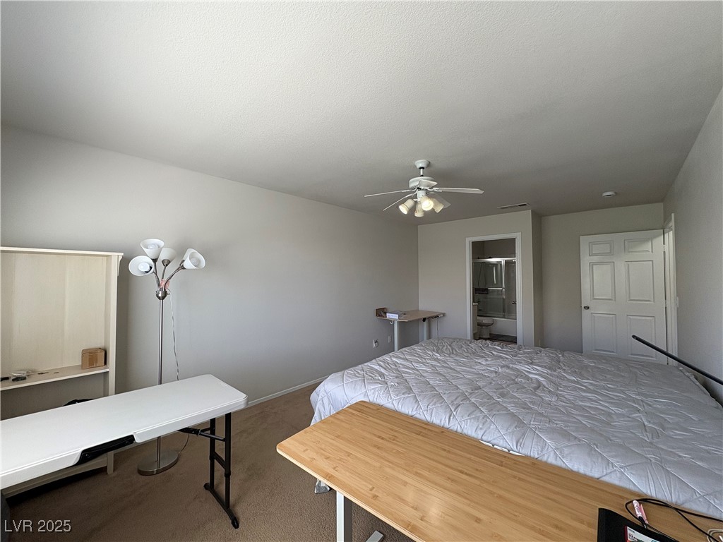 7931 Trea Avenue Las Vegas, NV 89147 - Photo 14 of 25 Bedroom featuring carpet floors, ceiling fan, and connected bathroom