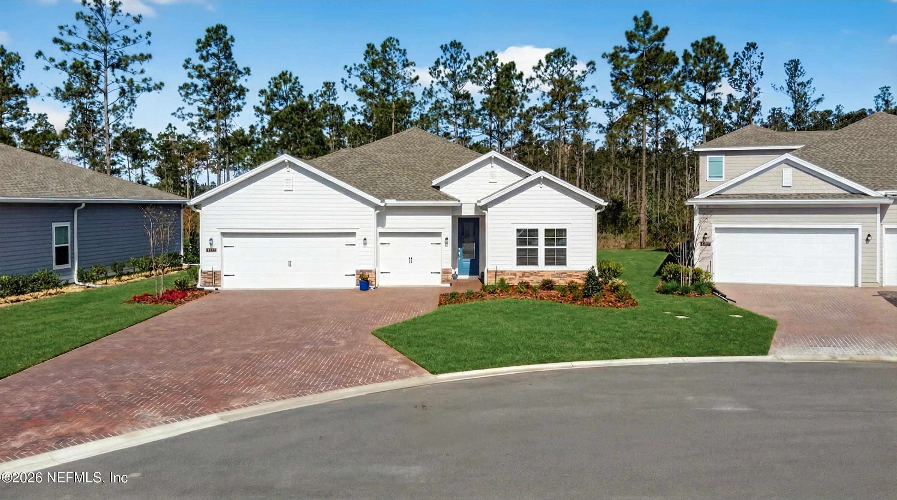 75263 Weathersford Place Yulee, FL 32097 - Photo 2 of 80 a view of a white house next to a yard and a large tree