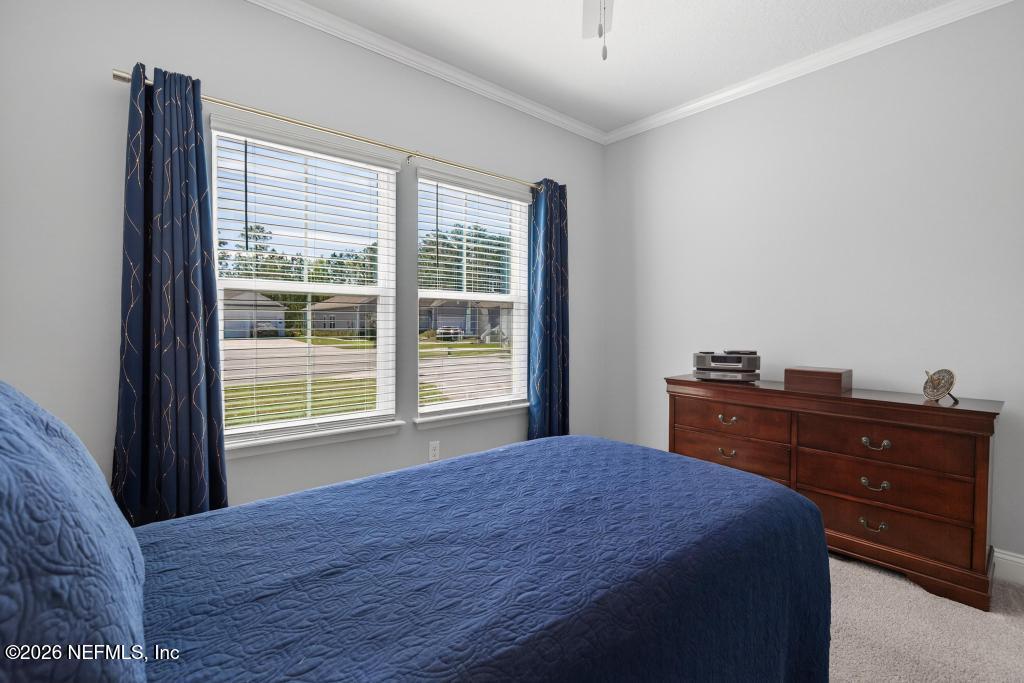 75263 Weathersford Place Yulee, FL 32097 - Photo 26 of 80 a bedroom with a bed and a window