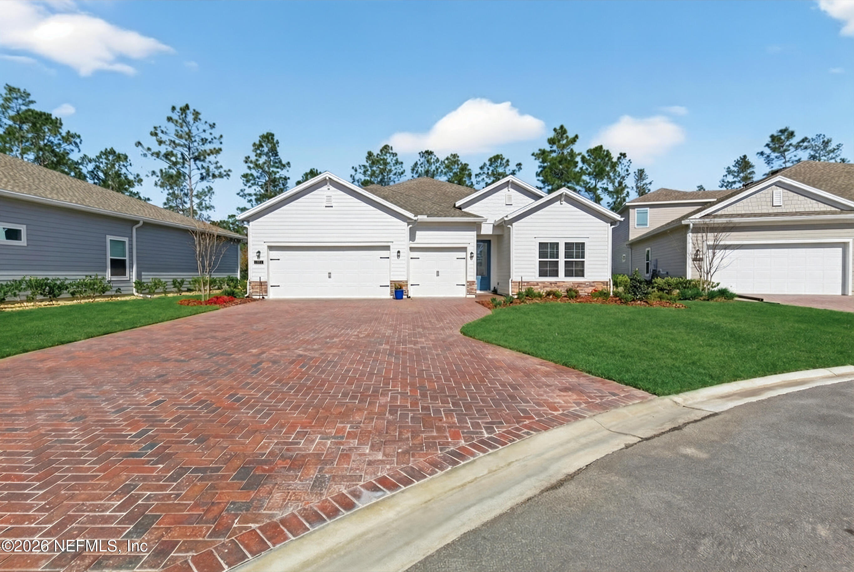 75263 Weathersford Place Yulee, FL 32097 - Photo 3 of 80 a front view of a house with a yard and potted plants