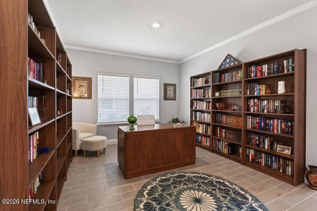 75263 Weathersford Place Yulee, FL 32097 - Photo 31 of 80 a living room with a couch and a book shelf