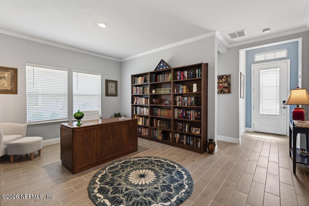75263 Weathersford Place Yulee, FL 32097 - Photo 32 of 80 a living room with furniture and a rug