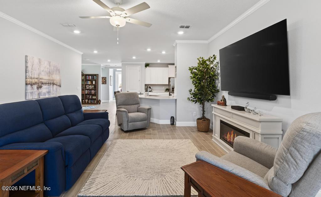 75263 Weathersford Place Yulee, FL 32097 - Photo 36 of 80 a living room with furniture and a flat screen tv