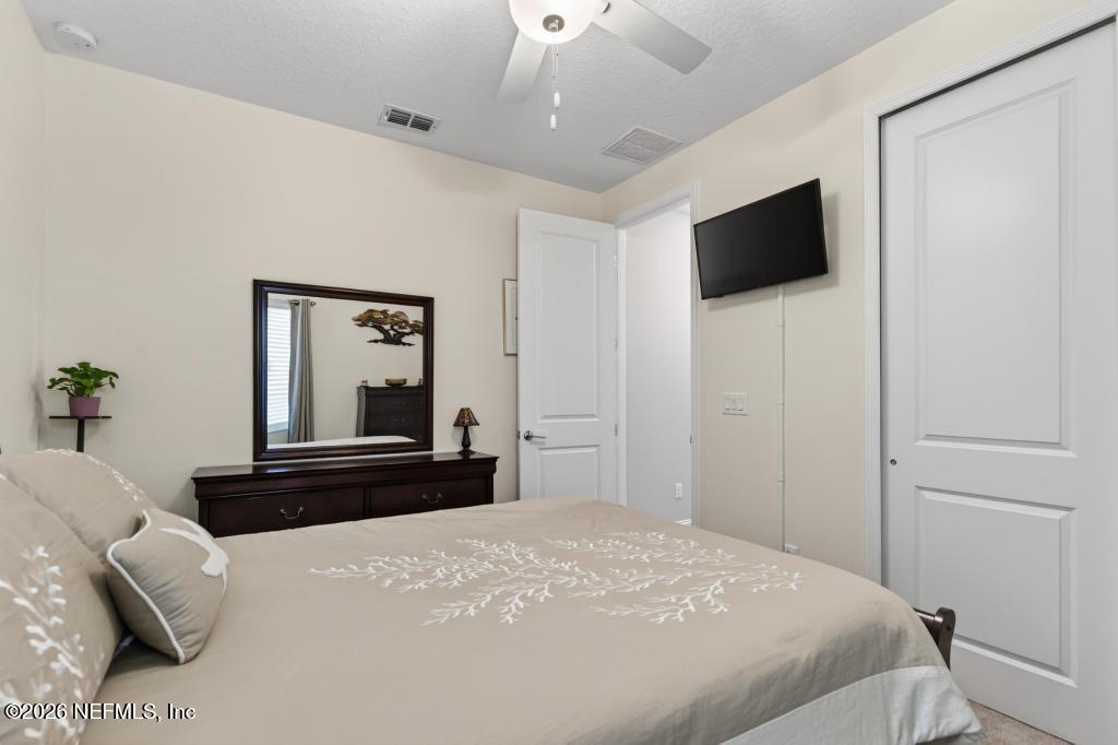 75263 Weathersford Place Yulee, FL 32097 - Photo 44 of 80 a bedroom with a bed and a flat screen tv