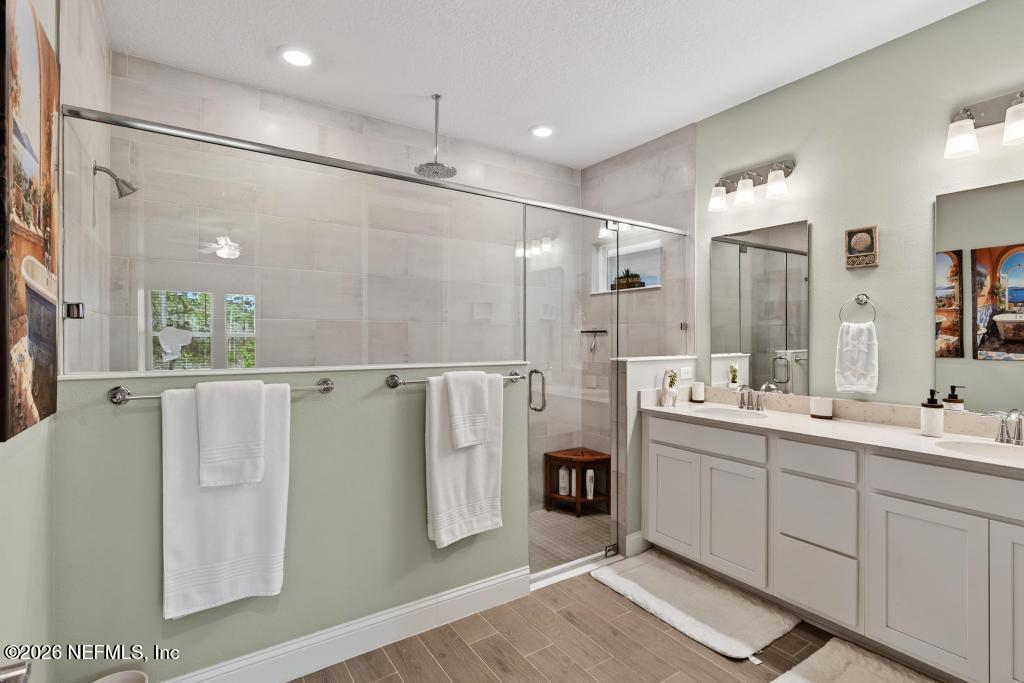75263 Weathersford Place Yulee, FL 32097 - Photo 48 of 80 a bathroom with a double vanity sink mirror and shower