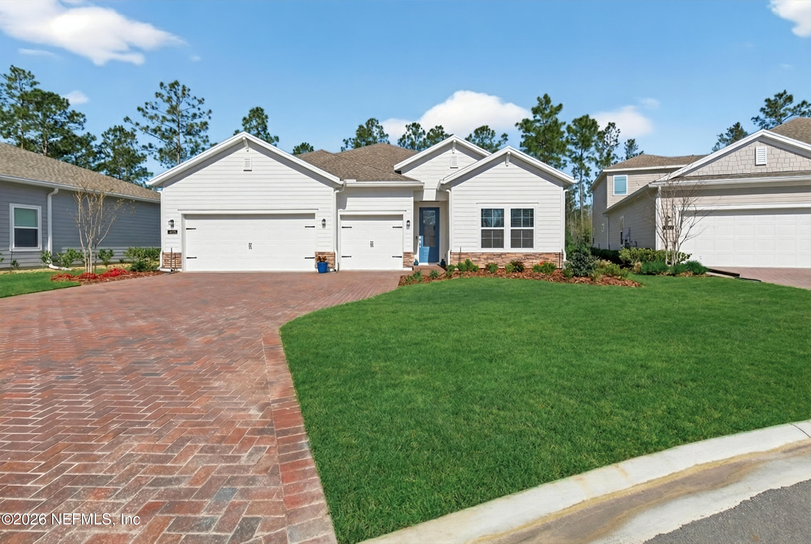 75263 Weathersford Place Yulee, FL 32097 - Photo 5 of 80 a front view of a house with a yard and garage