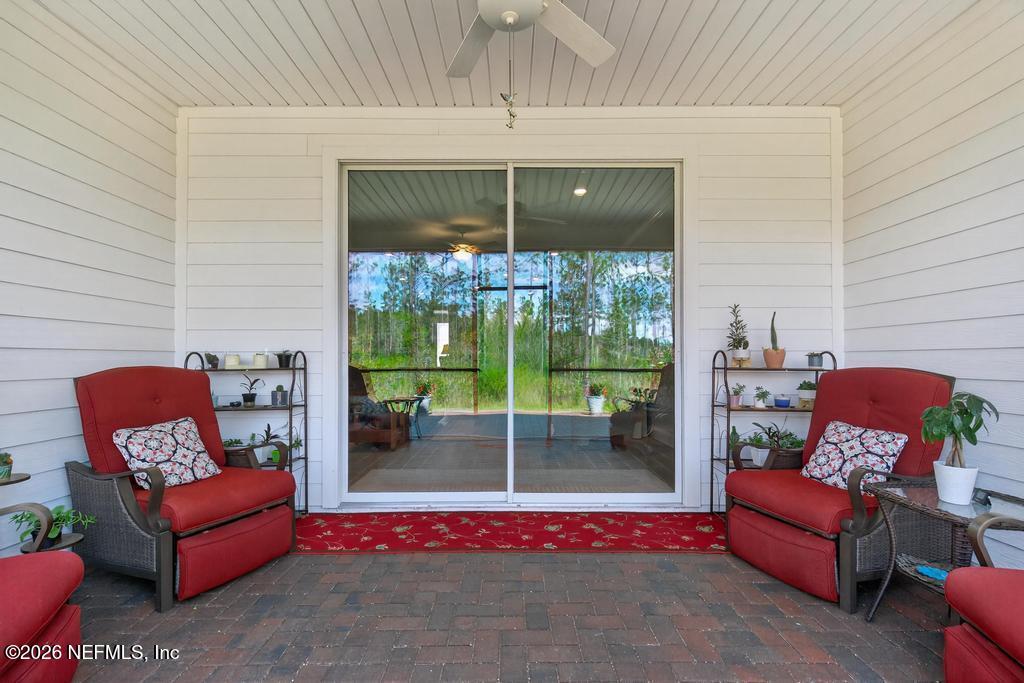 75263 Weathersford Place Yulee, FL 32097 - Photo 58 of 80 a outdoor living space with patio furniture and a potted plants