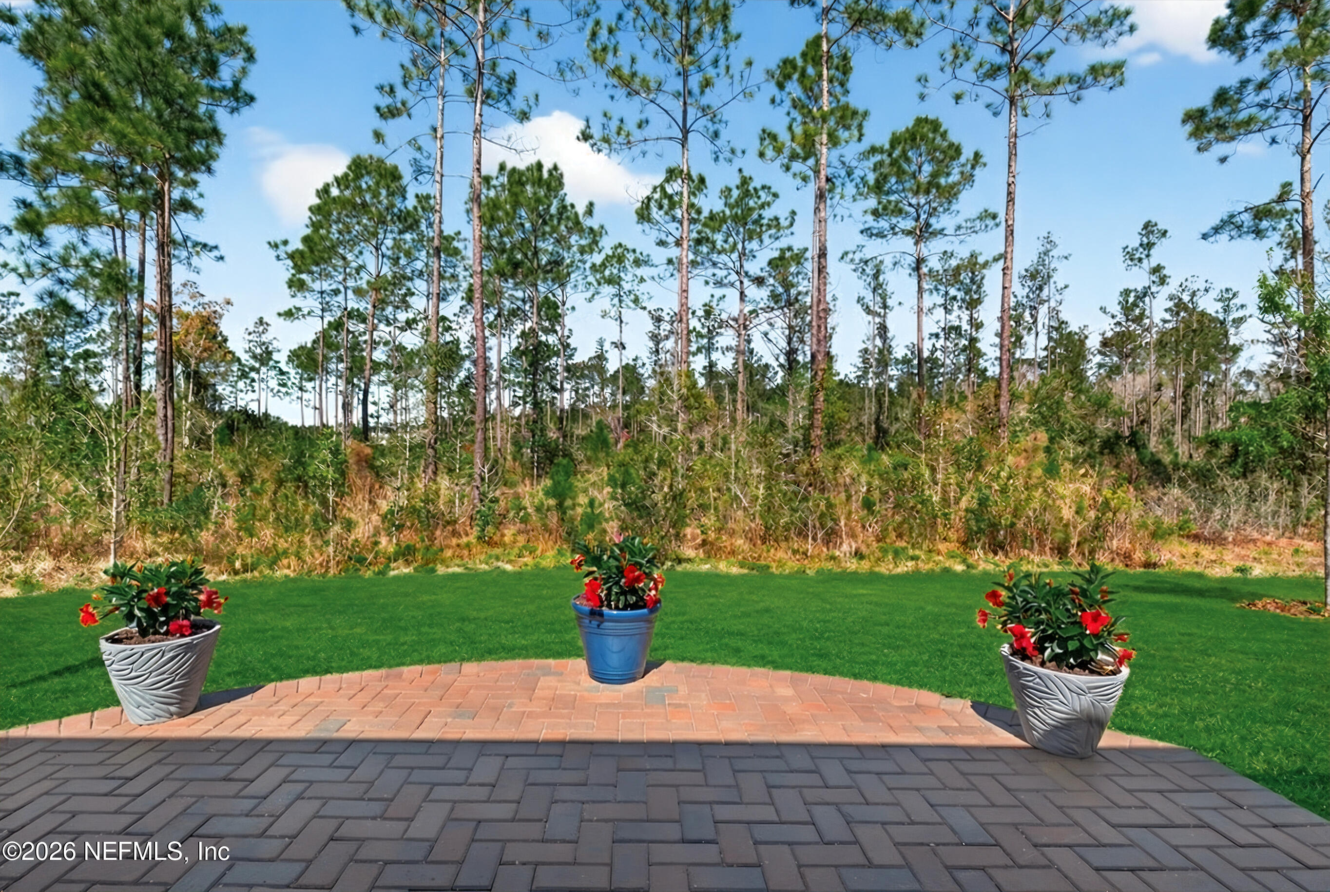 75263 Weathersford Place Yulee, FL 32097 - Photo 59 of 80 a view of a house with a yard and potted plants