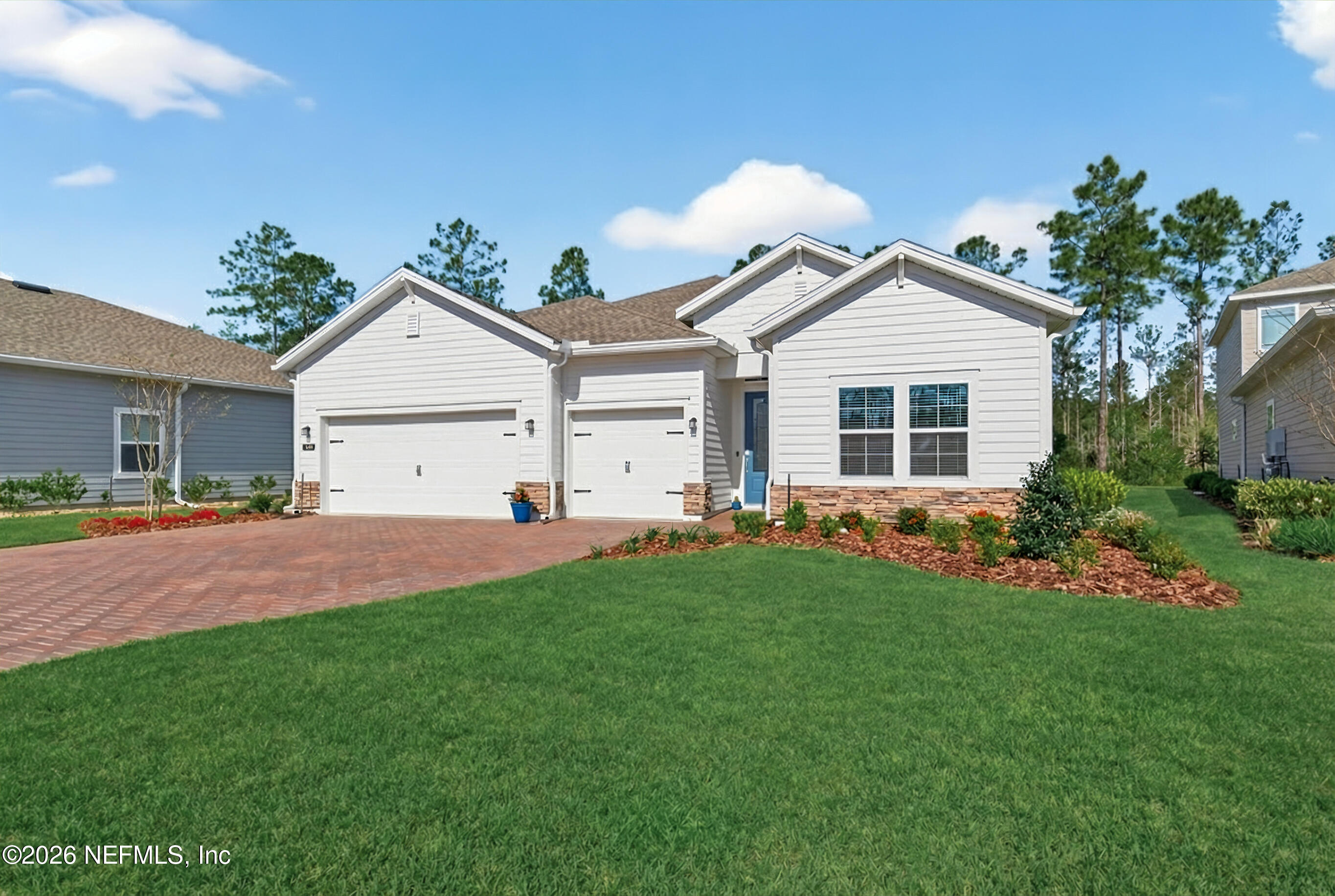75263 Weathersford Place Yulee, FL 32097 - Photo 6 of 80 a front view of a house with a yard and garage