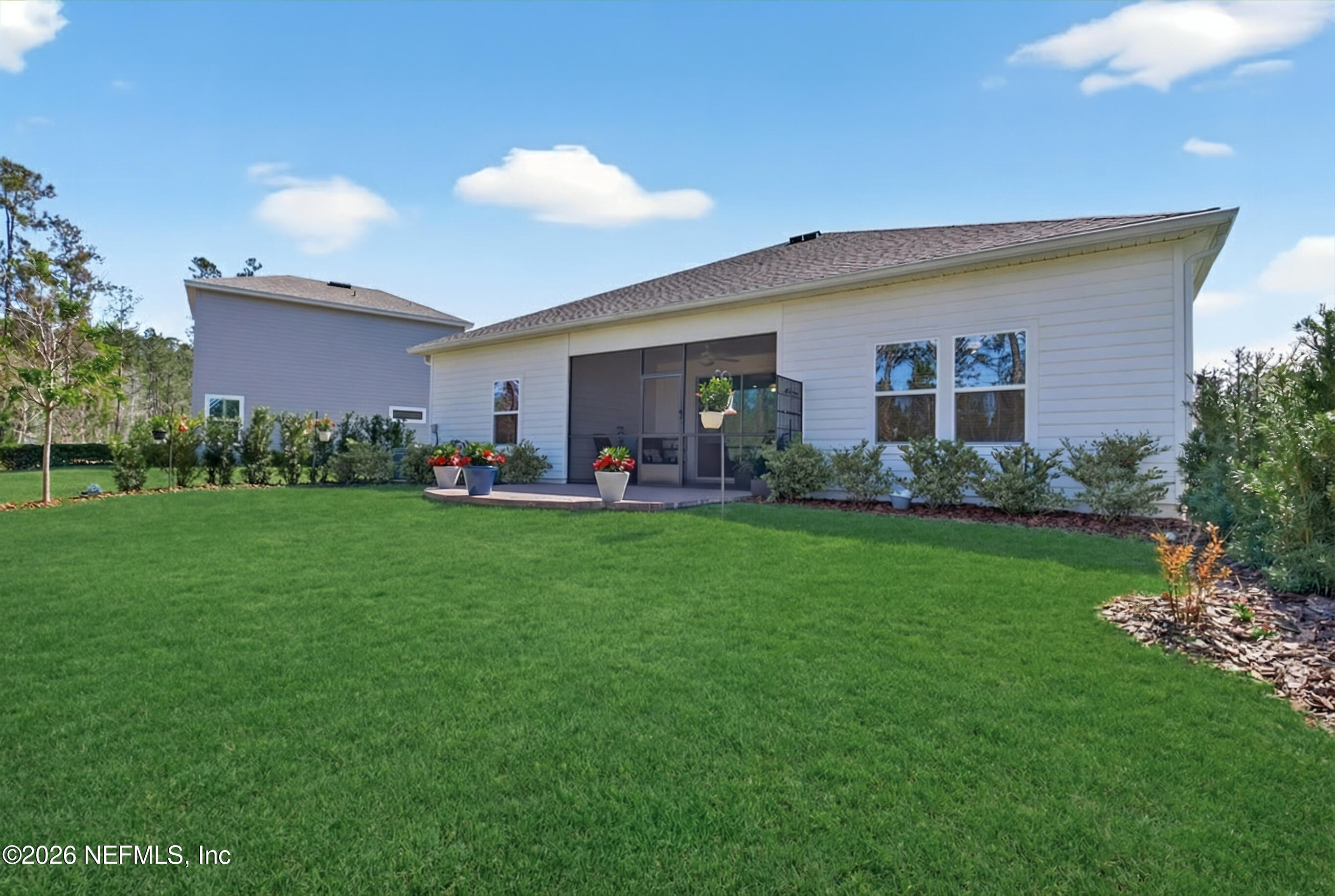 75263 Weathersford Place Yulee, FL 32097 - Photo 62 of 80 a front view of house with yard and outdoor seating