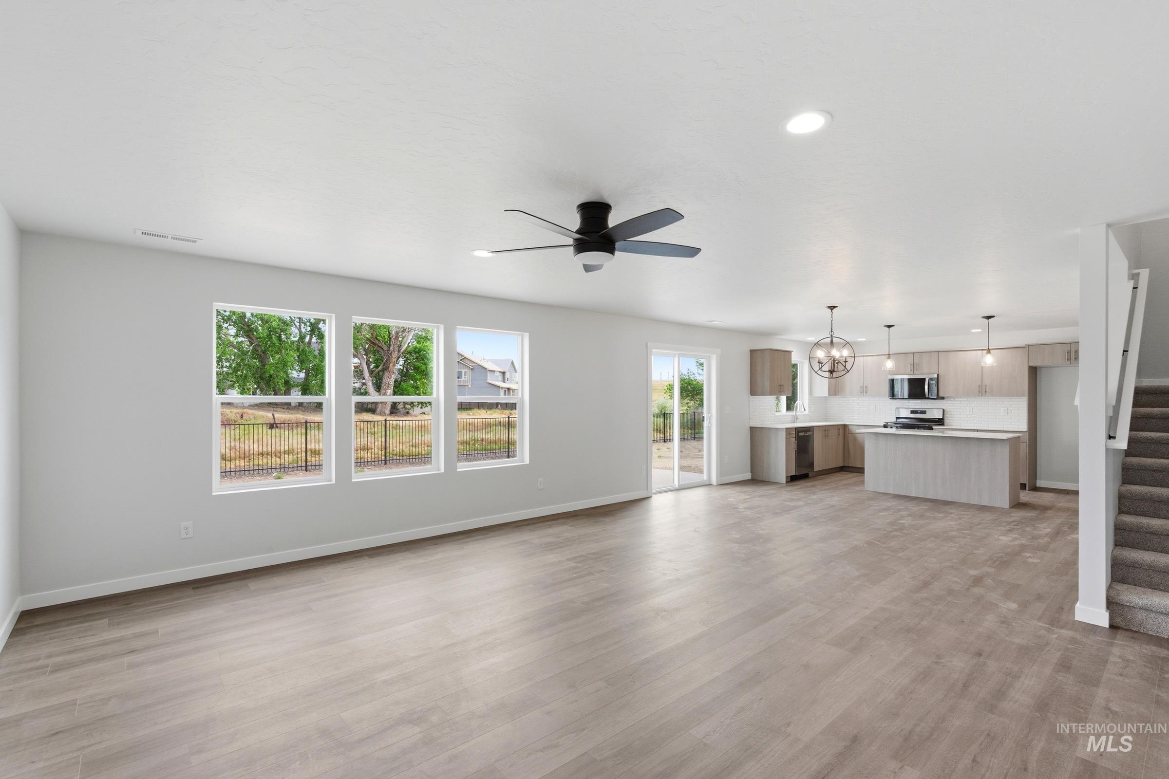12829 Decatur Street Nampa, ID 83651 - Photo 10 of 33 Open-concept living area featuring wood-finish flooring, recessed lighting, and a contemporary ceiling fan