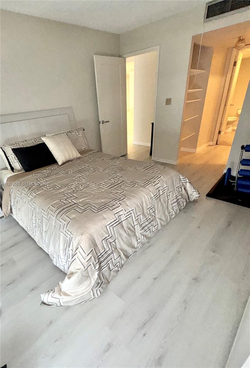 600 Northeast 36th Street, Unit 720 Miami, FL 33137 - Photo 8 of 26 a bedroom with a bed and a window