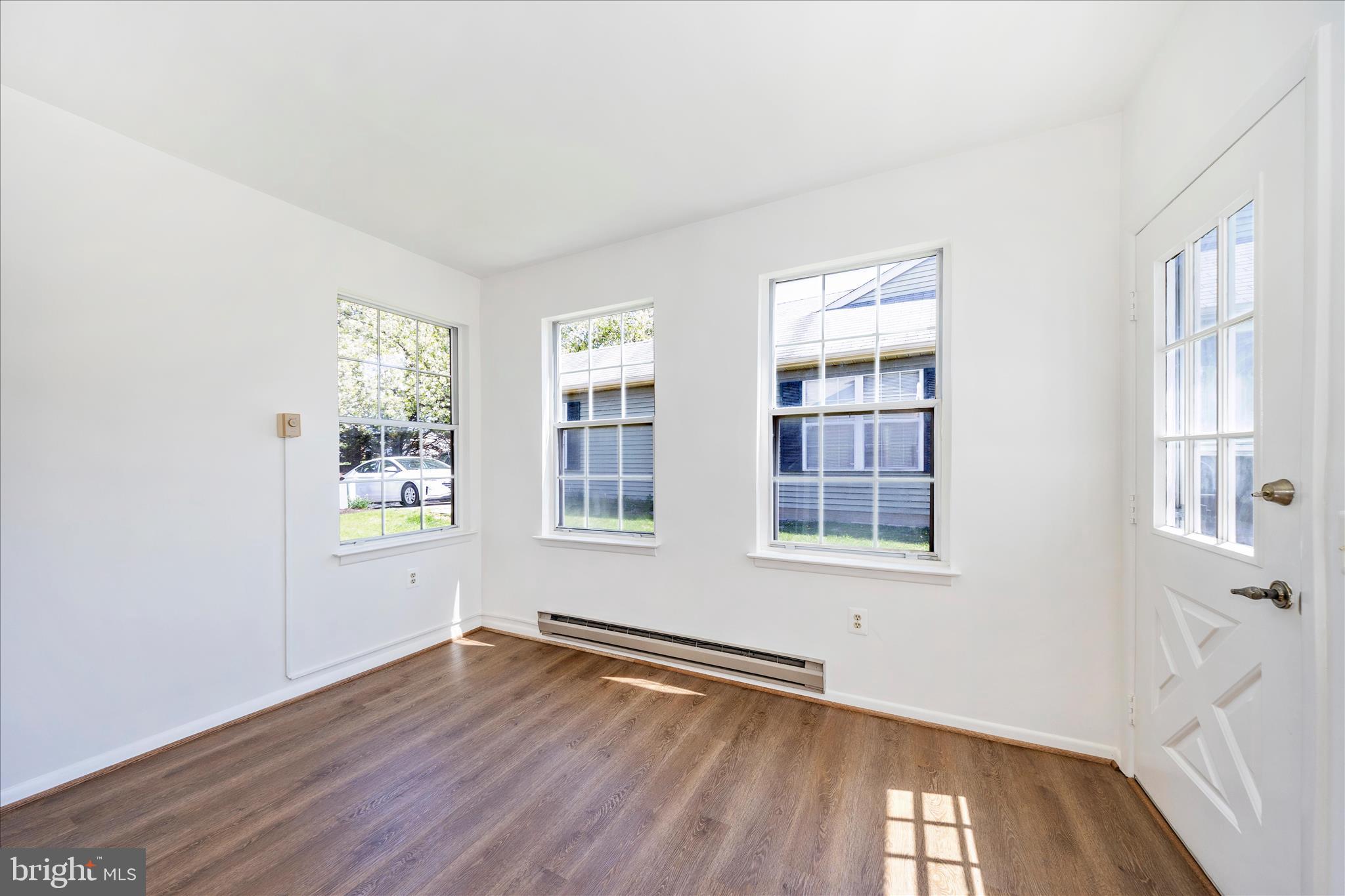 5738 Box Elder Court Frederick, MD 21703 - Photo 8 of 50 an empty room with wooden floor and windows